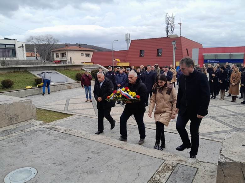 A group of people walking down a sidewalkDescription automatically generated